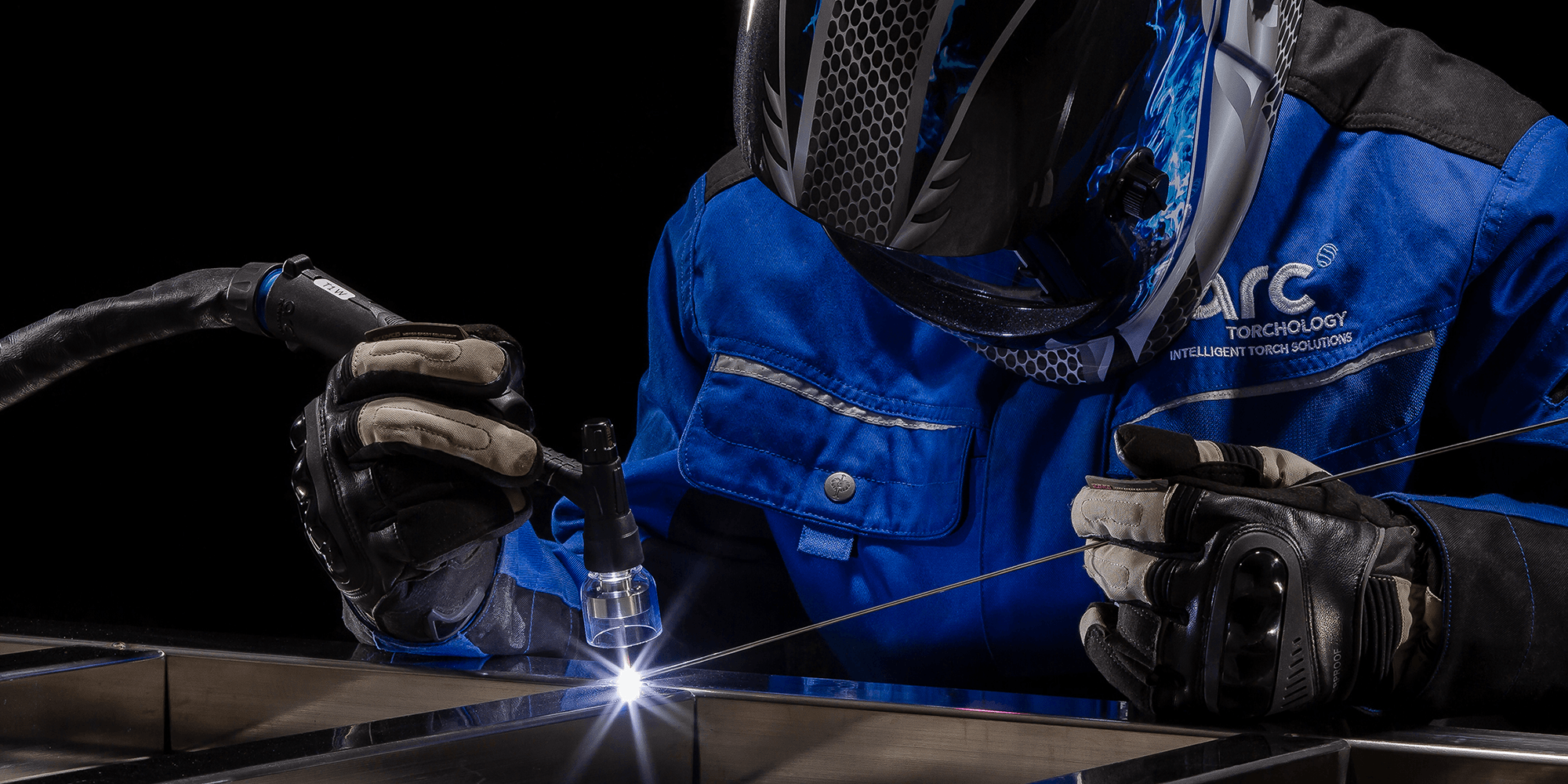 Welder using an Arc T Tig welding torch with a Super Series quartz gas lens.