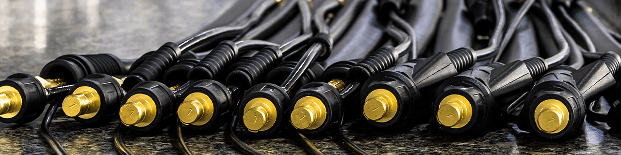 Multiple Tig torches arranged on a work bench with cables laid out and cable ends aligned, demonstrating precision, high quality construction.